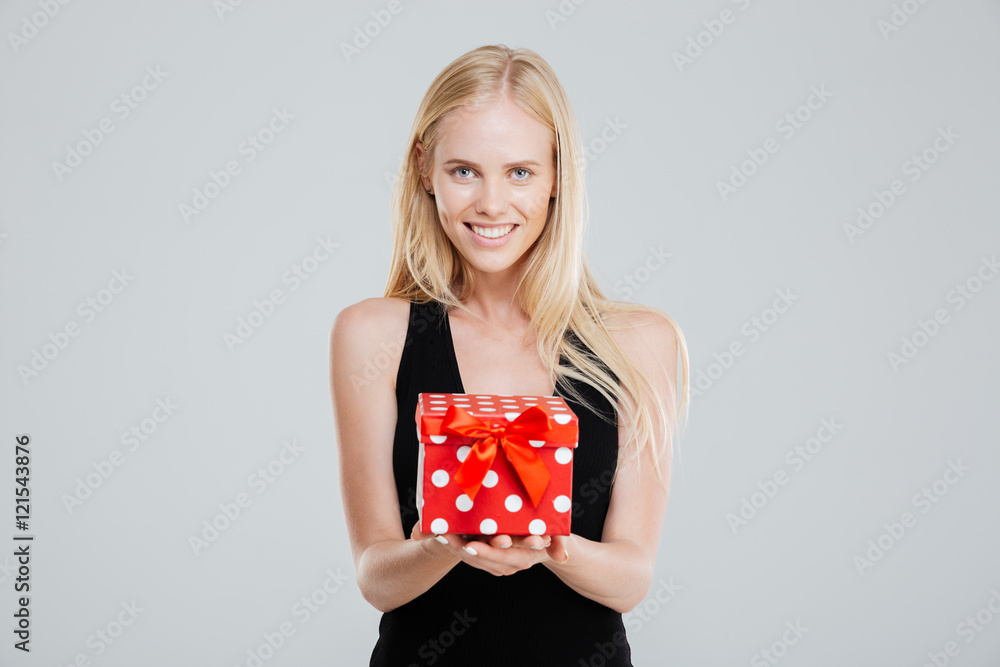 Happy young woman in black dress holding gift box Happy young woman in black dress holding gift box