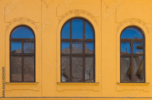 Windows with an arch with sky reflection