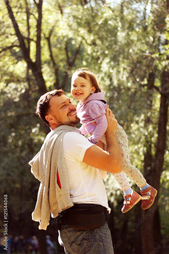 Father playing with his little daughter in autumn park Father playing with his little daughter in autumn park