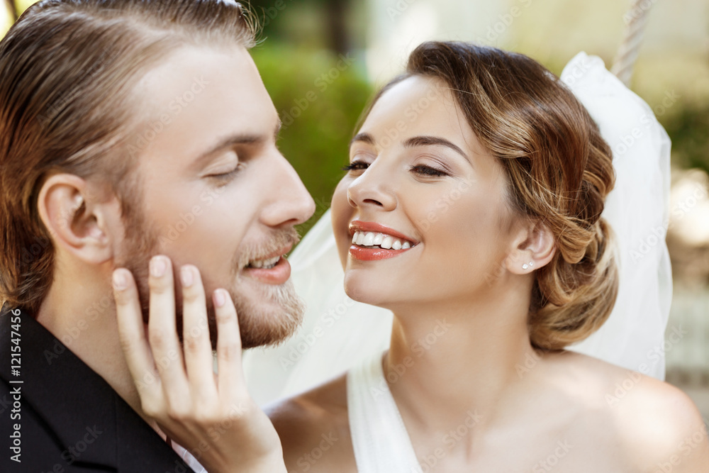 Happy beautiful newlyweds in suit and wedding dress smiling, enjoying. Happy beautiful newlyweds in suit and wedding dress smiling, enjoying.