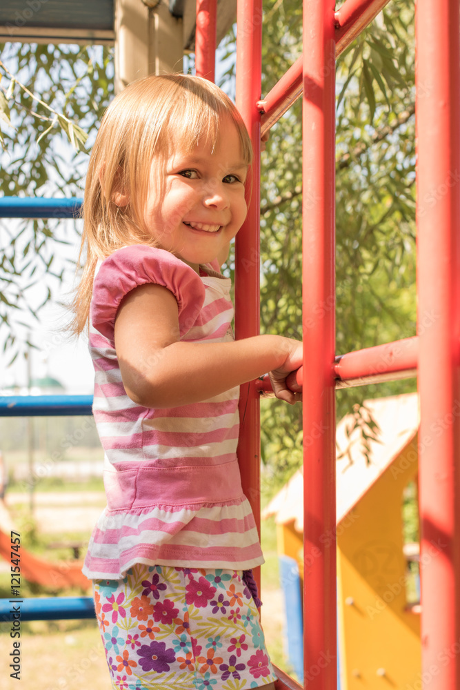 Sweet girl 3 year old playing in the Playground, climbs on the bar
Sweet girl 3 year old playing in the Playground, climbs on the bar
