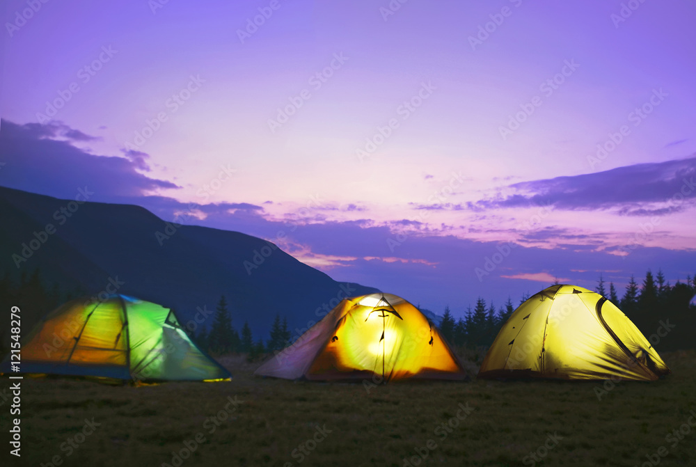 Illuminated camping tents  in dark blue sky ,Carpathian ,Ukraine