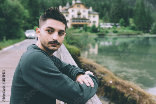 Man watching a lake and mou...