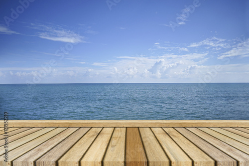 Empty top wooden table and beautiful peace sea in background. Can use for product display