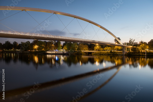 The modern High Bridge is nicely reflected in the smooth water of the Meuse river.