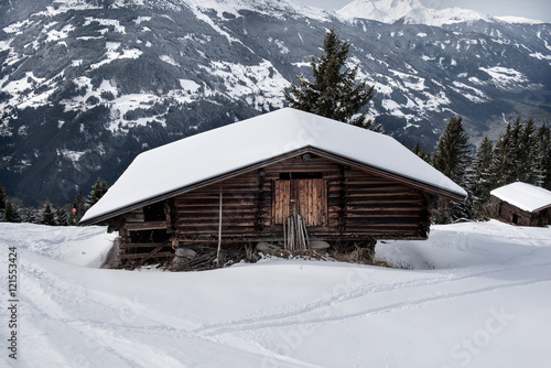 Wooden shed on the slopes of a snowy mountain in the Zillertal, Austria © nielsvos