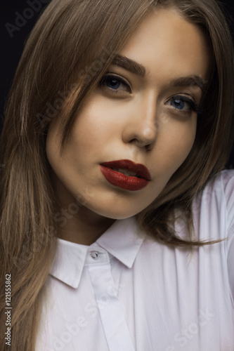 beautiful woman with red lips on a black background.