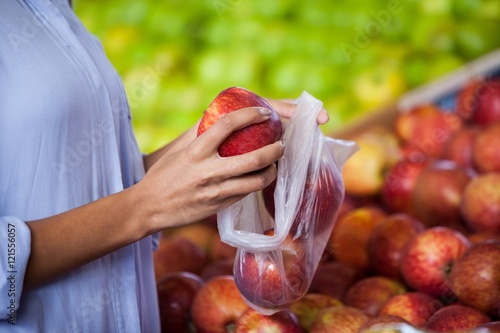 Woman buying an apple