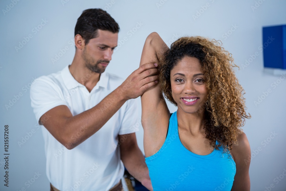 Physiotherapist giving arm massage to female patient Physiotherapist giving arm massage to female patient