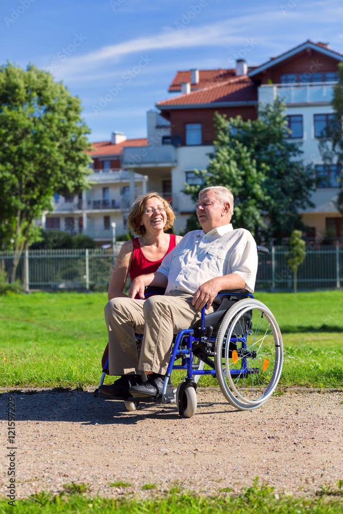 man on wheelchair with young woman