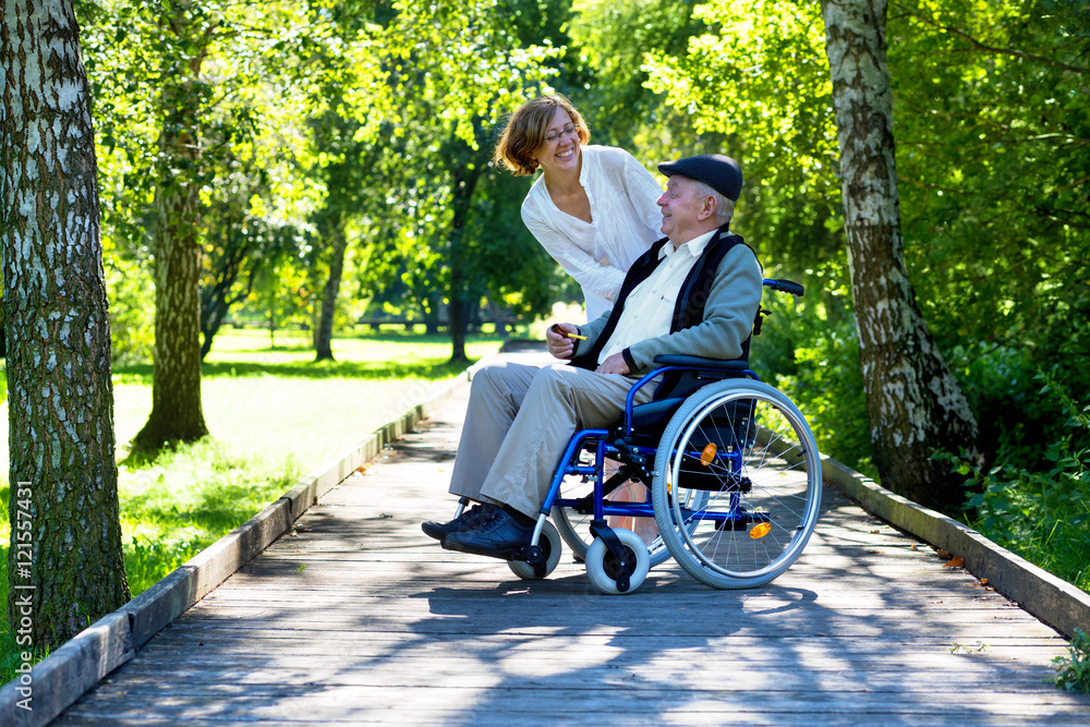 old man on wheelchair and young woman in the park Stock Photo | Adobe Stock
