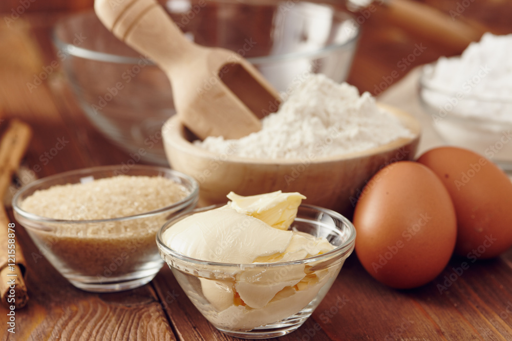 Ingredients to make a cake or a dessert on an aged wooden table Ingredients to make a cake or a dessert on an aged wooden table