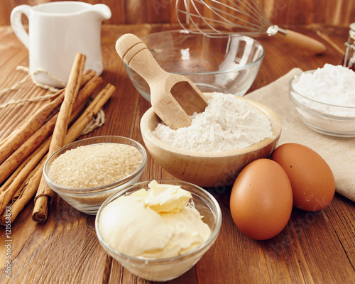 Ingredients to make a cake or a dessert on an aged wooden table
