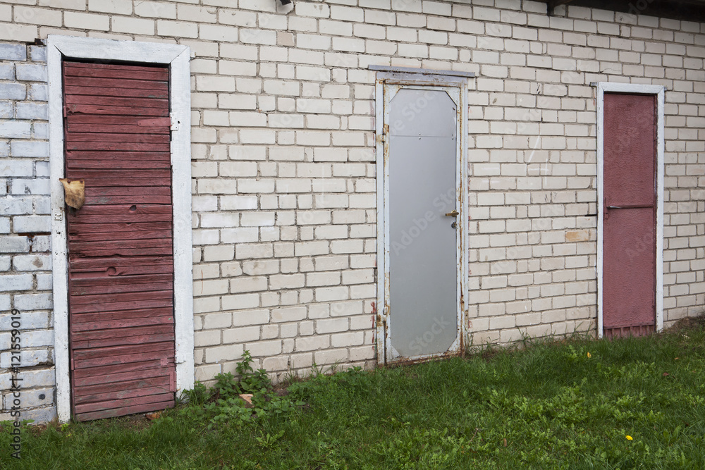 Three doors in the brick wall. Purple and gray. Three doors in the brick wall. Purple and gray.