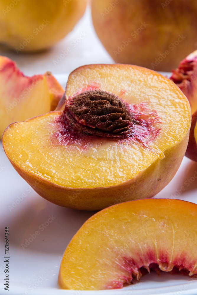 cut peach on white plate cut peach on white plate