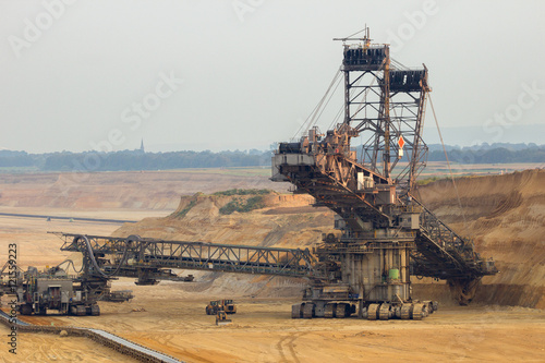 Brown coal open pit mine with mining equipment.