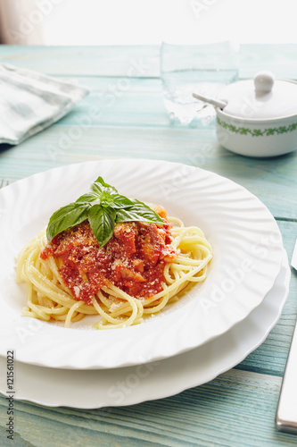 spaghetti amatriciana on a blue wooden table (Italian dish)