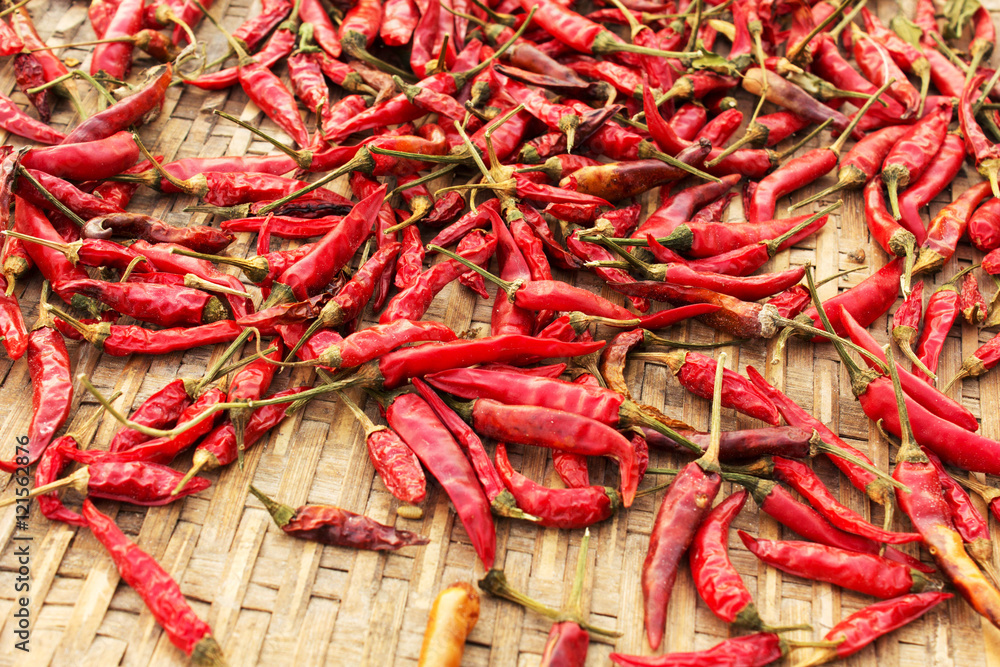 Red chili pepper dried. bamboo texture and background