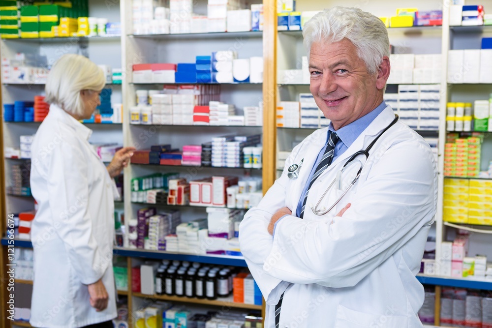 Pharmacist standing with arms crossed Pharmacist standing with arms crossed