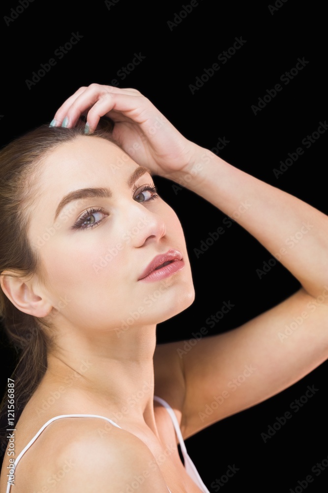 Portrait of beautiful woman posing against black background Portrait of beautiful woman posing against black background