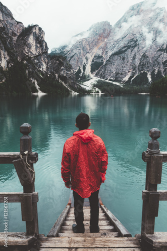 man with red raincoat on wo...