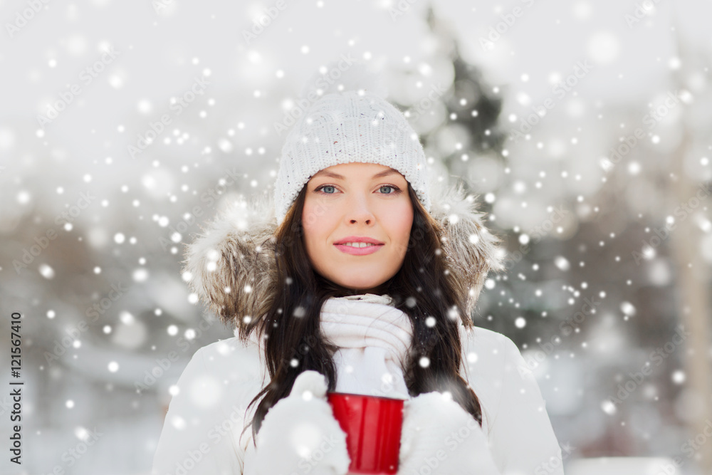 happy young woman with tea cup outdoors in winter happy young woman with tea cup outdoors in winter