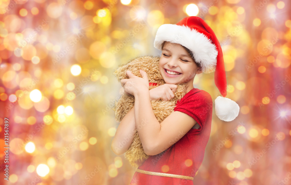 smiling girl in santa helper hat with teddy bear smiling girl in santa helper hat with teddy bear
