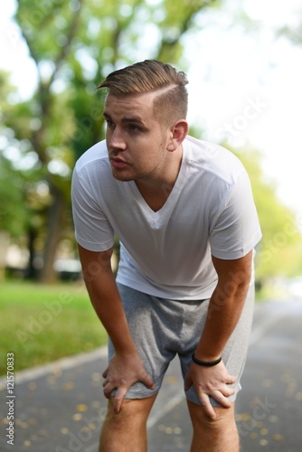 Blonde attractive man resting after jogging