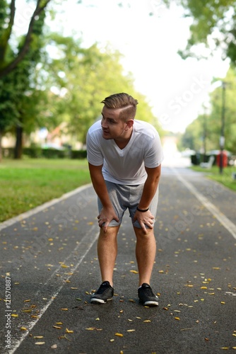 Blonde attractive man resting after jogging