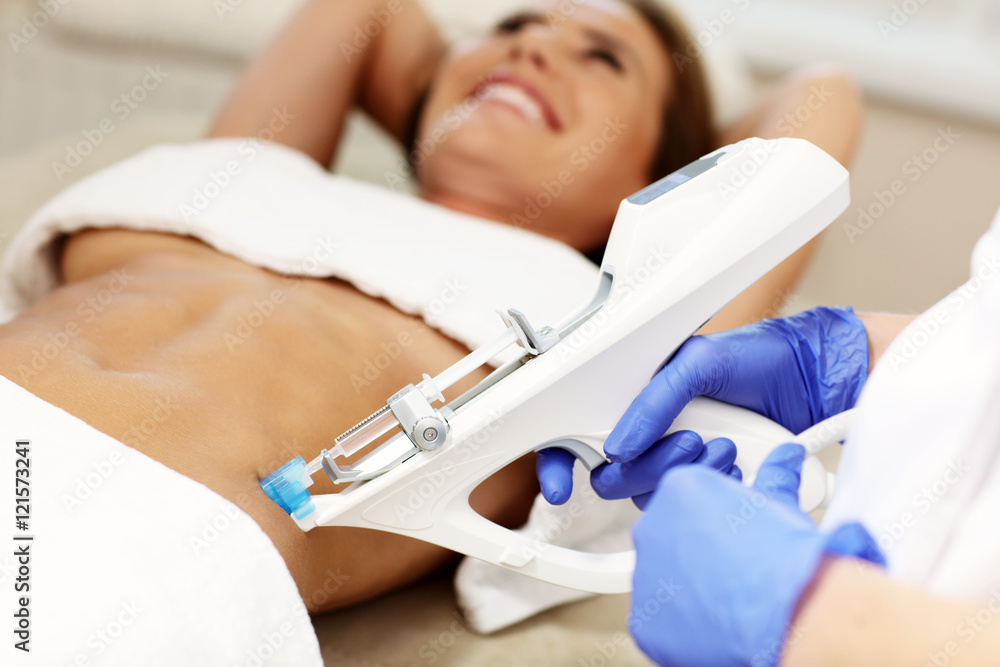 Fototapeta premium Woman having abdomen mesotherapy in beauty salon