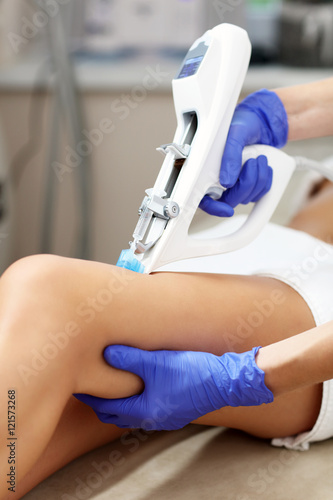 Woman having leg mesotherapy in beauty salon