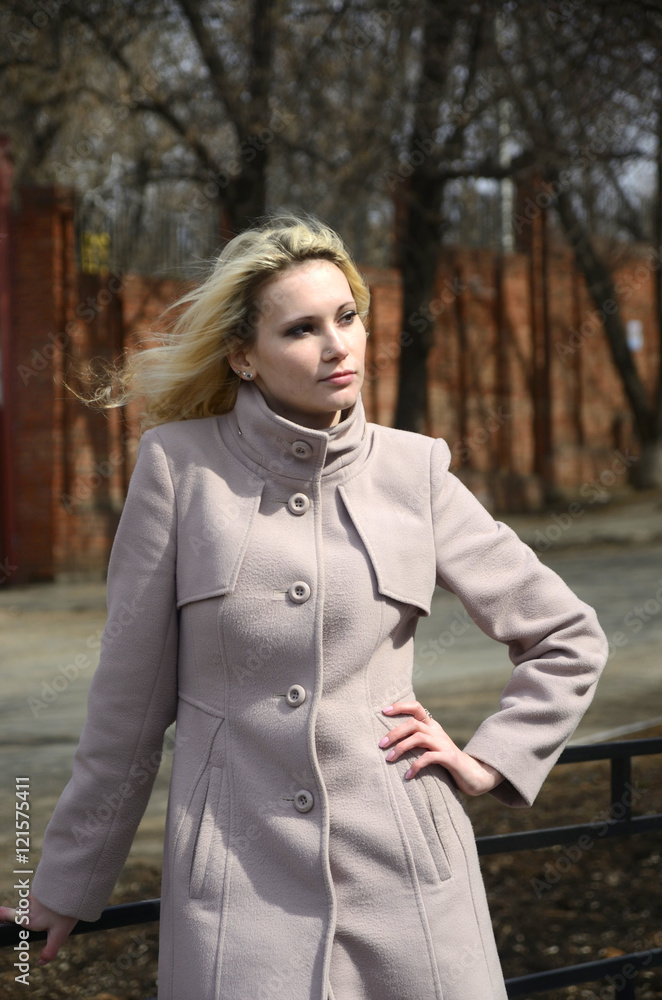 the girl walks in coat in the city the girl walks in coat in the city