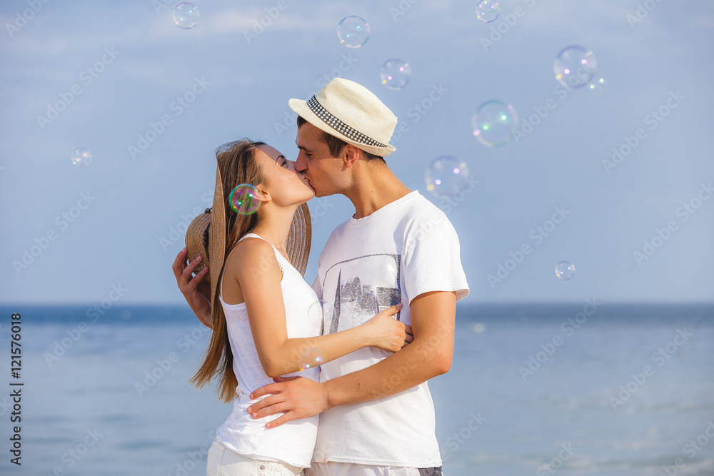 Attractive couple cuddling at the beach Attractive couple cuddling at the beach