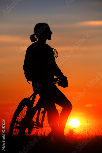 Silhouette of a bike on sky background photo