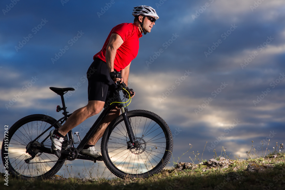 Man in helmet and glasses stay on the bicycle