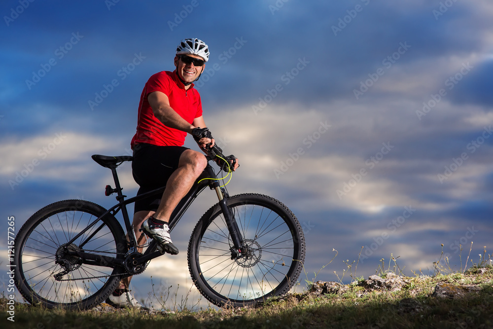 Fototapeta premium Man in helmet and glasses stay on the bicycle