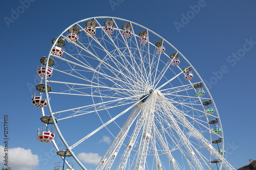Colorful Ferris wheel against blue summer sky background