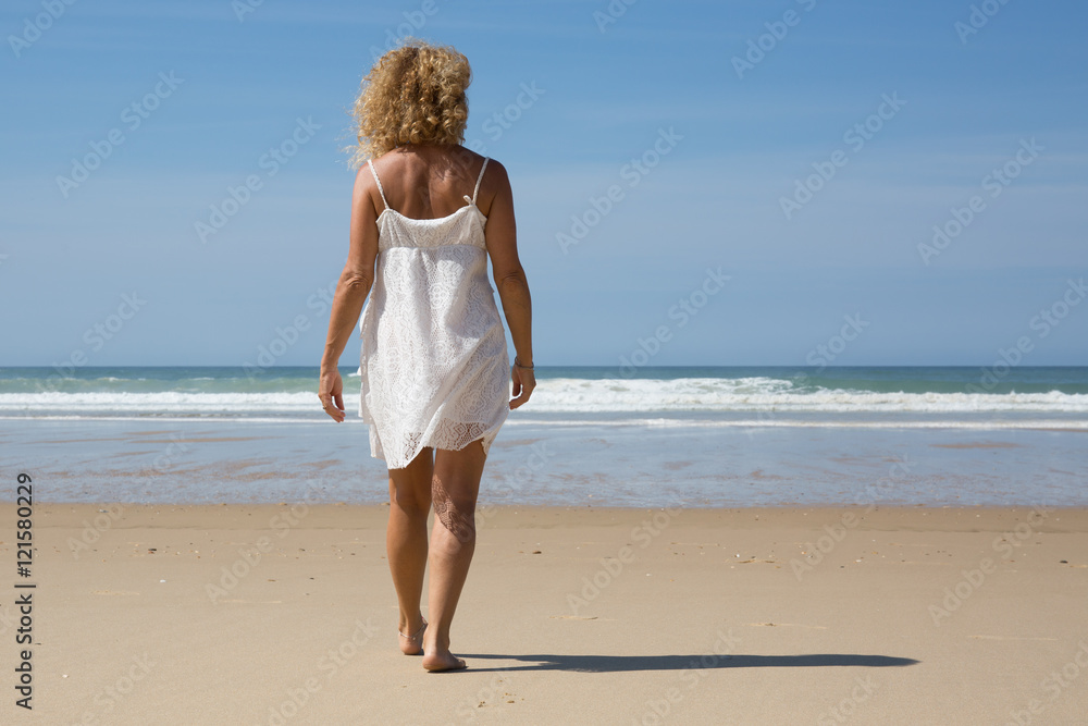 Pretty Beautiful woman legs, walking on the beach Pretty Beautiful woman legs, walking on the beach