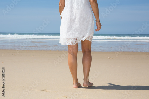 Beautiful woman legs, walking on the beach