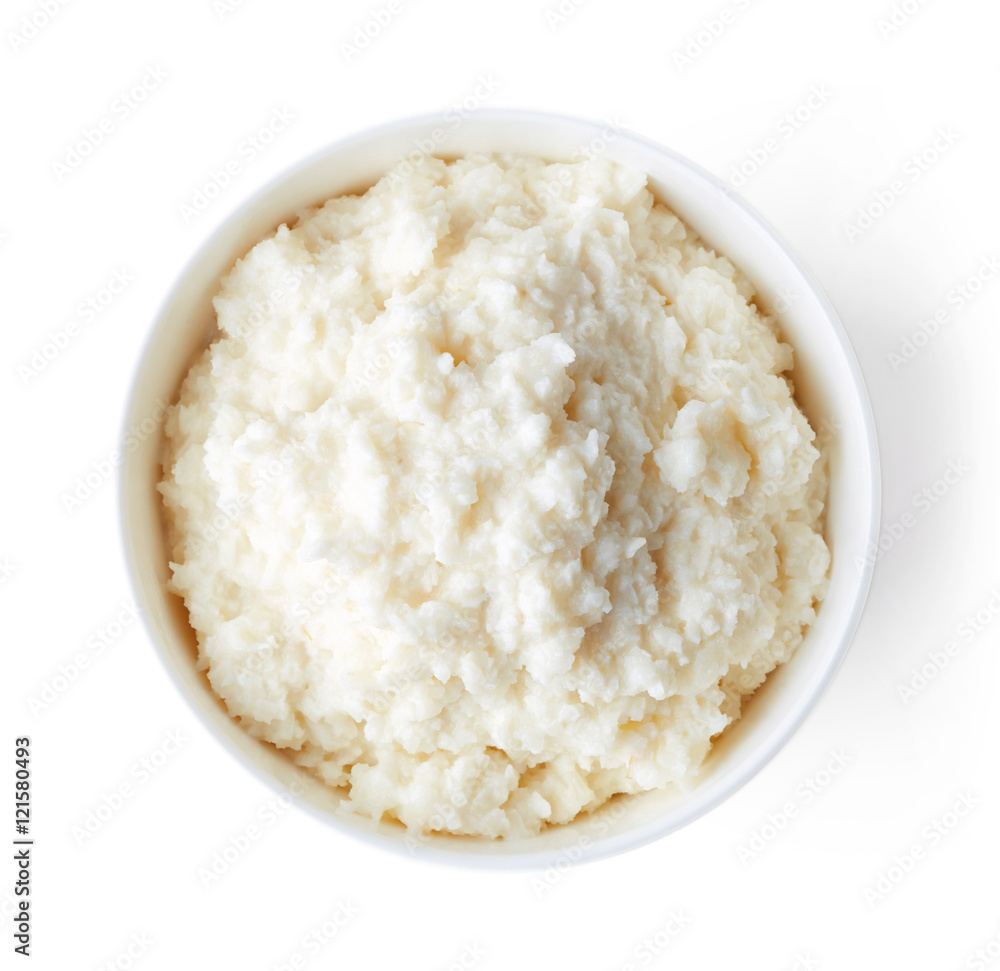 Bowl of rice flakes porridge isolated on white, from above Bowl of rice flakes porridge isolated on white, from above