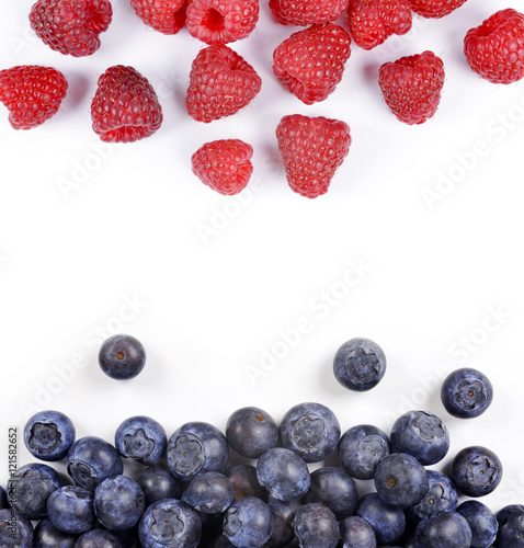Raspberries and blueberries isolated on white background