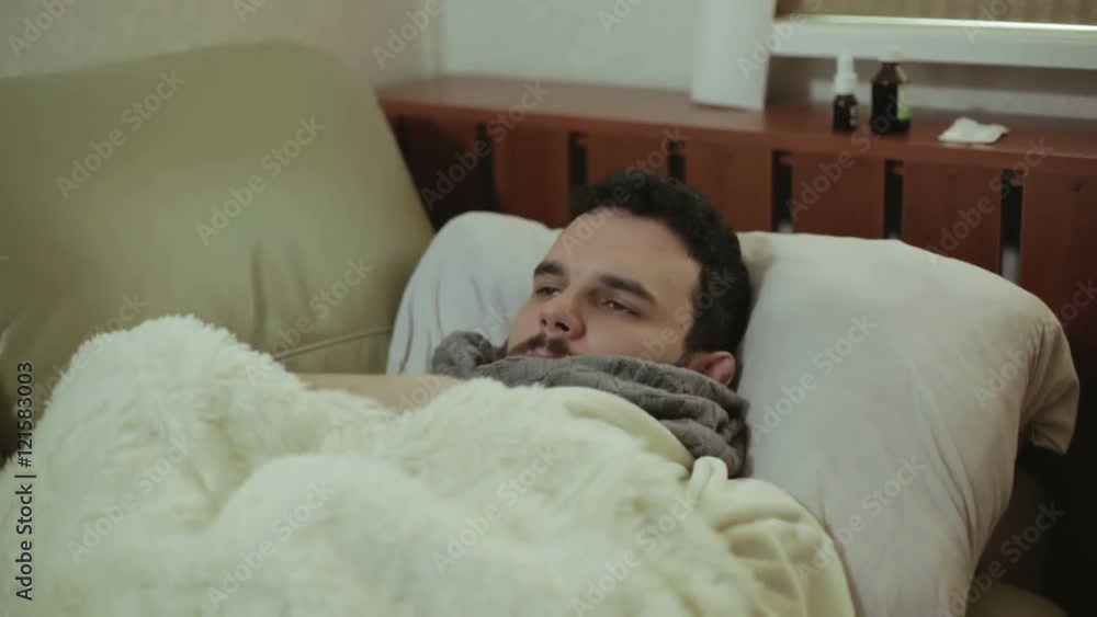 An ill guy taking his temperature. An ill guy taking his temperature.