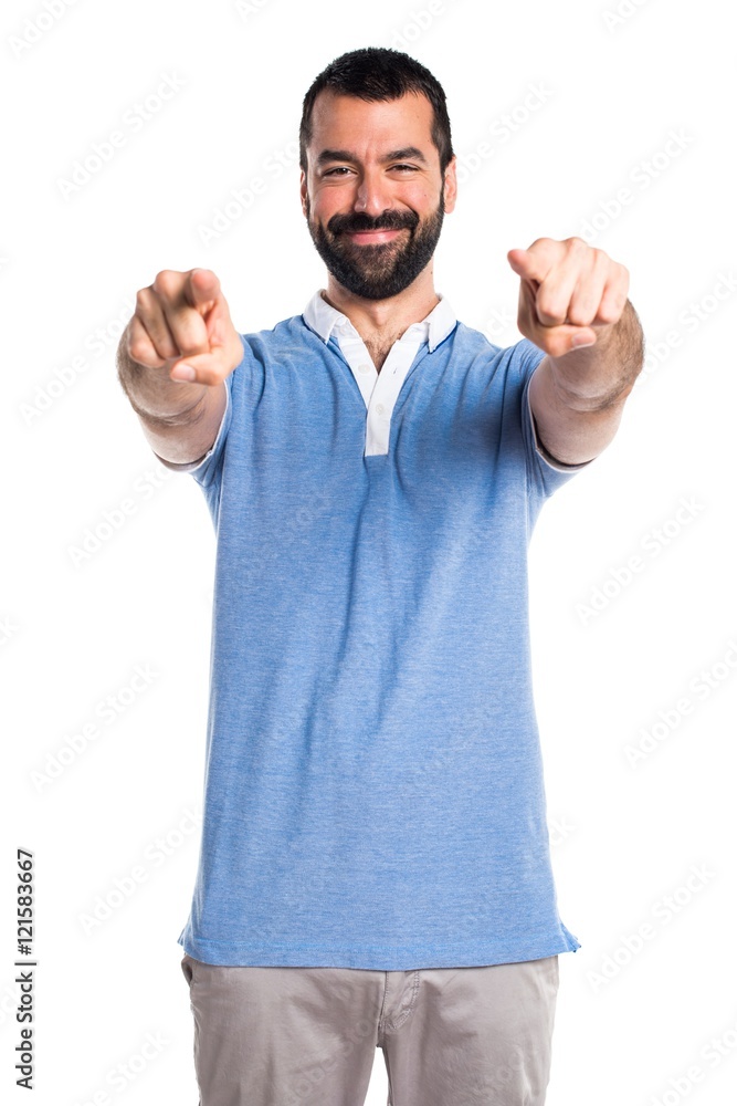 Man with blue shirt pointing to the front Man with blue shirt pointing to the front