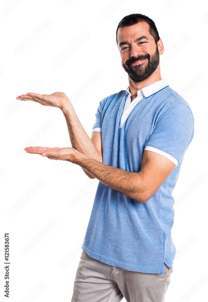 Man with blue shirt presenting something Man with blue shirt presenting something