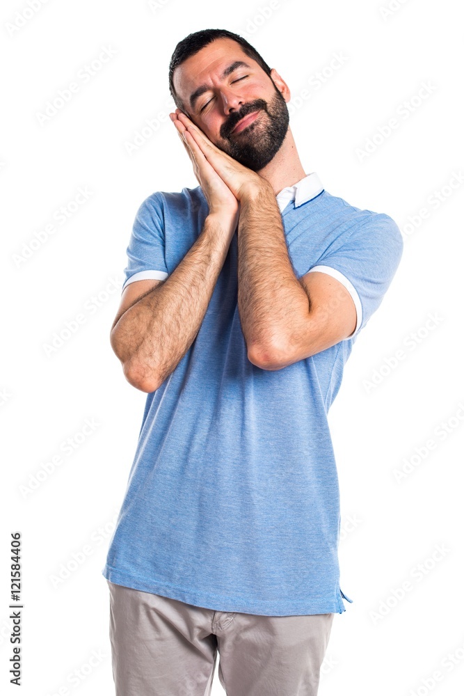 Fototapeta premium Man with blue shirt doing sleep gesture