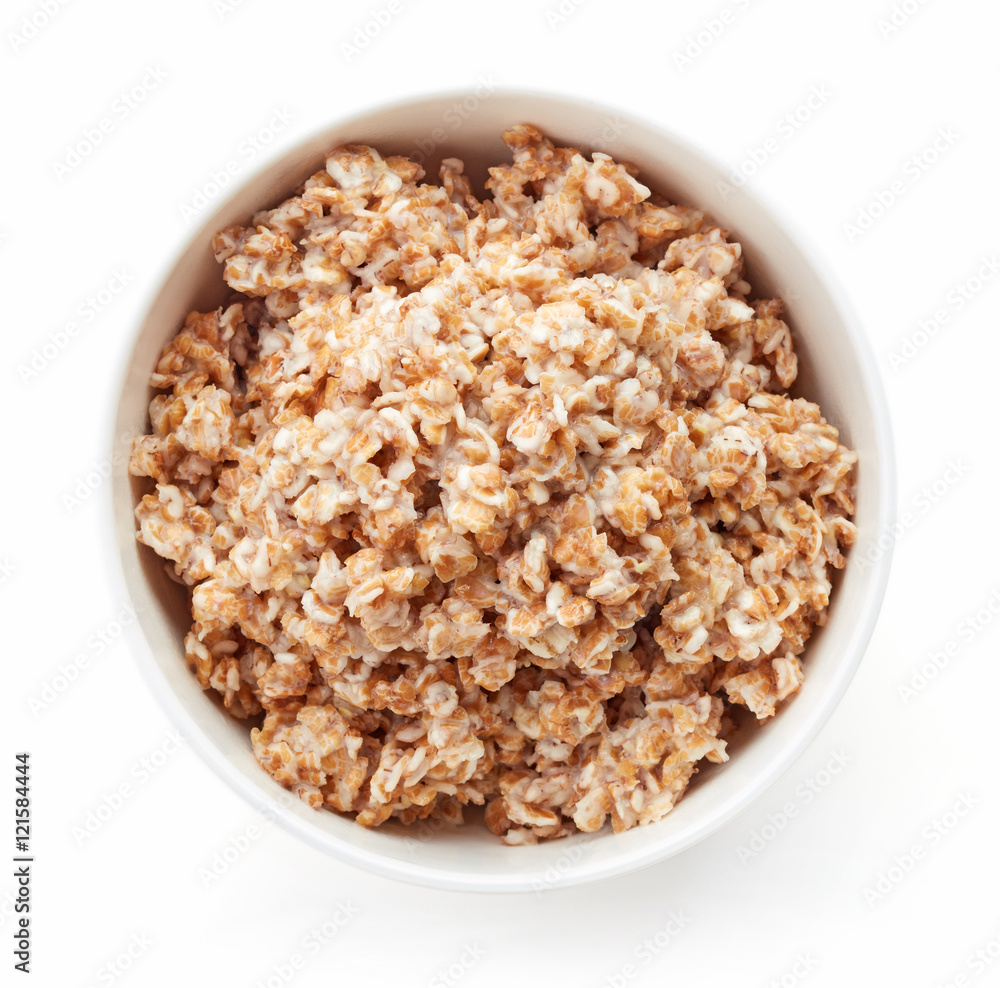Bowl of rye flake porridge isolated on white, from above Bowl of rye flake porridge isolated on white, from above