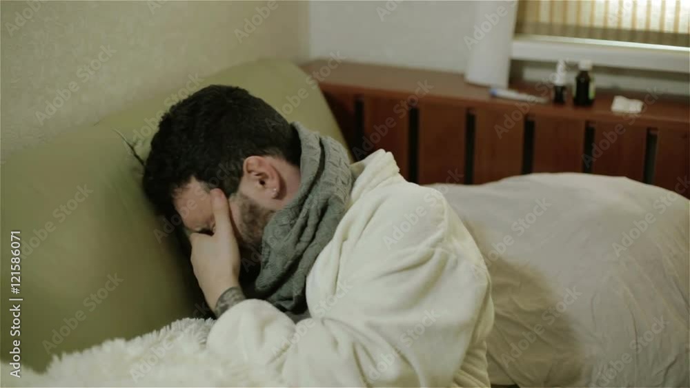 An ill man rubbing his eyes. An ill man rubbing his eyes.