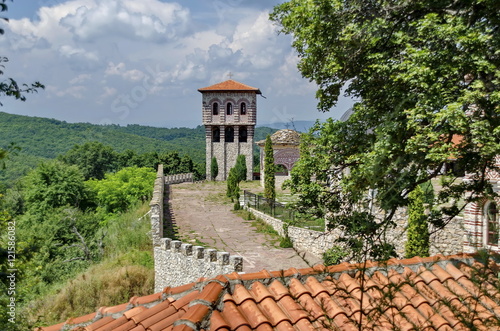 View of inner part yard with bell tower in restored Montenegrin or Giginski monastery St. St. Cosmas and Damian, mountain, Kitka, Breznik, Pernik region, Bulgaria 