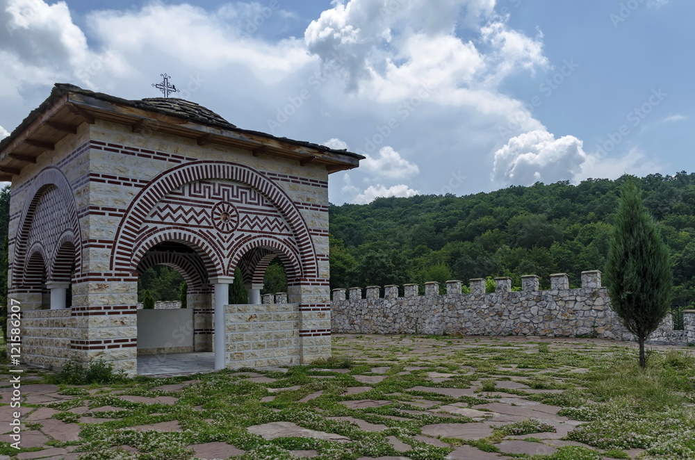 Fototapeta premium Stone slate-roof of old medieval alcove with cross in restored Montenegrin or Giginski monastery St. St. Cosmas and Damian, mountain Kitka, Breznik, Pernik region, Bulgaria 