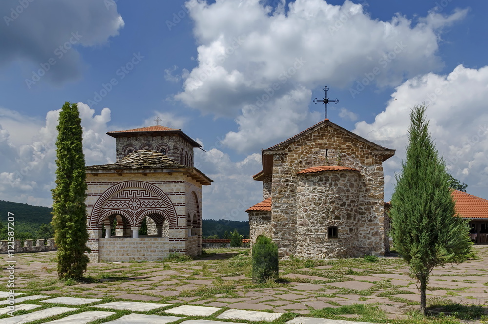 View of inner yard with old medieval church, alcove and bell tower in restored Montenegrin or Giginski monastery St. St. Cosmas and Damian, mountain Kitka, Breznik, Pernik region, Bulgaria View of inner yard with old medieval church, alcove and bell tower in restored Montenegrin or Giginski monastery St. St. Cosmas and Damian, mountain Kitka, Breznik, Pernik region, Bulgaria